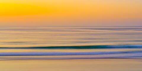 an abstract panoramic image of sunset at La Jolla shores beach creating a painterly feel with camera movement.  Abstract photography by Andrew Shoemaker