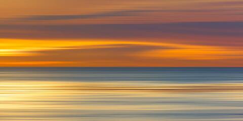 Abstract California sunset with golden light sweeping across the Pacific Ocean