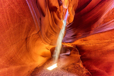 a beam of light shooting into the magnificent upper antelope canyon near Page, Arizona.  Fine art southwest photography by artist Andrew Shoemaker