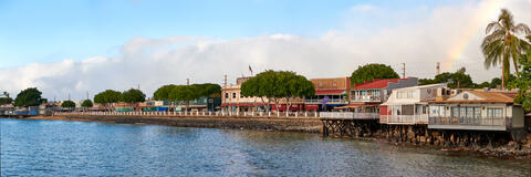 a beautiful panorama of the famous Front Street in downtown Lahaina featuring a rainbow in the background.  Front Street was tragically destroyed by a fire 