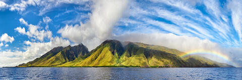 panorama of the island of Maui photographed from a boat off of Olowalu featuring a rainbow