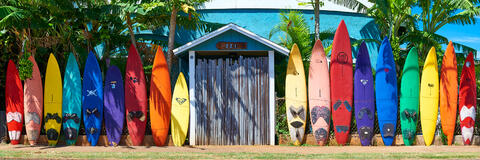 a very colorful surfboard fence in the same sequence as the rainbow found in Paia on the north shore of Maui