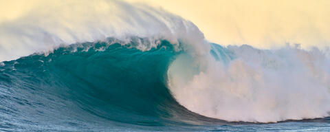 a beautiful large wave breaking at the surf break off the north shore of Maui known as Jaws or Peahi.  Hawaii wave photography by Andrew Shoemaker