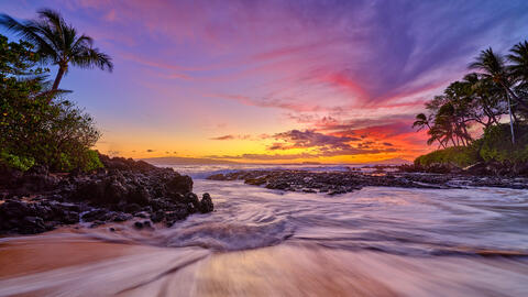 pink, purple and magenta sunset panoramic photograph at secret beach in Makena on the island of Maui