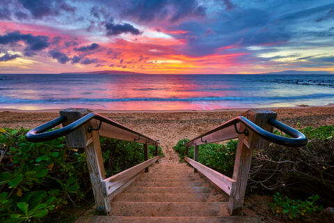 Looking down a beach staircase on to Ulua Beach in Wailea at sunset on the island of Maui.  Photographed by Andrew Shoemaker