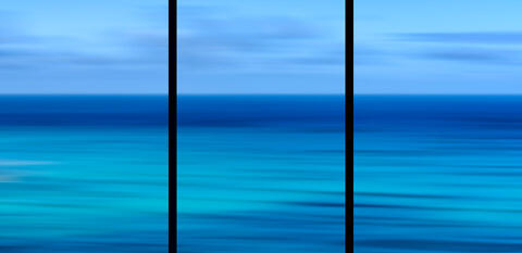 Abstract Waikiki Beach ocean panoramic photography on Oʻahu, Hawaii, featuring intentional camera movement and tranquil blue coastal tones.