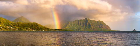 a beautiful panoramic photograph of the koolau mountain range with a rainbow at sunrise on the island of Oahu, Hawaii.  Landscape photo by Andrew Shoemaker