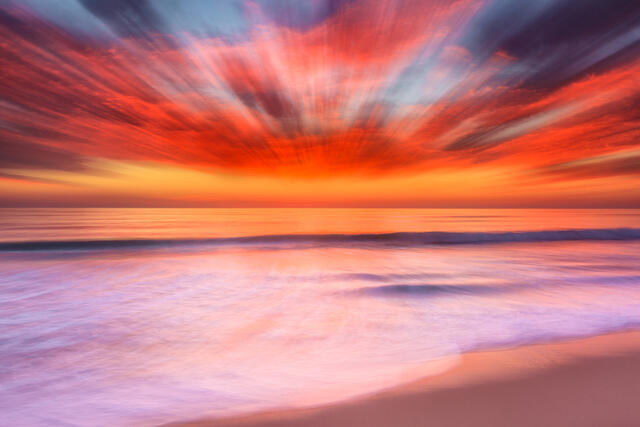 an abstract beach sunset image created using a zoom lens and a longer shutter speed resulting in a very unique photograph