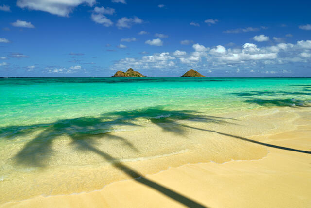 Serendipity is a fine art photograph from Andrew Shoemaker at Lanikai Beach on the Hawaiian island of Oahu featuring azure waters and two islands on the horizon