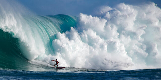 surfer Tyler Larronde surfing the biggest wave in Hawaii Jaws on the north shore of the island of Maui.