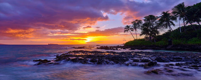 panoramic sunset with purple and violet tones at Secret Beach in Makena on the island of Maui