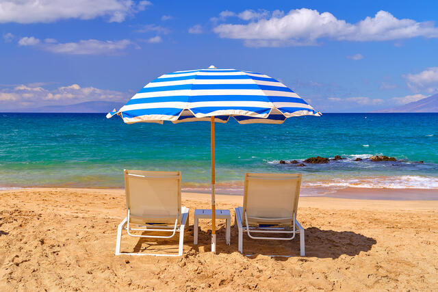 a Hawaii beach scene in Makena Maui at Maluaka Beach featuring a beach umbrella and 2 chairs.  Hawaii fine art nature photography by Andrew Shoemaker