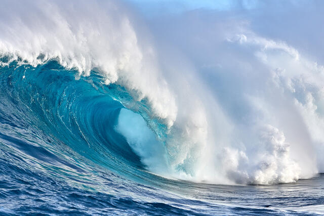 the biggest wave in Hawaii Jaws (also known as Peahi) breaks as photographer Andrew Shoemaker captures it's beautiful blue barrel.