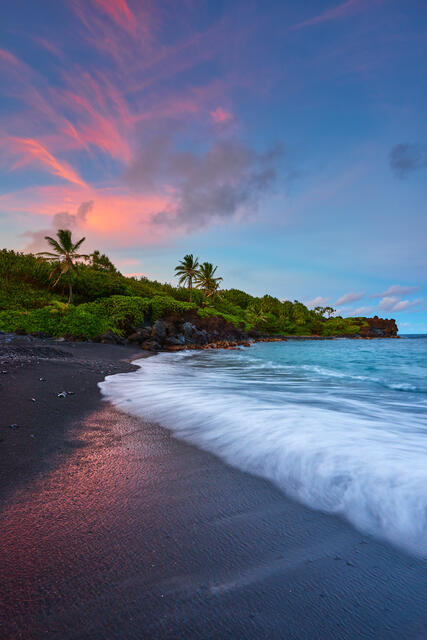 a photograph of sunset at the famous black sand beach at Waianapanapa State Park near Hana, Hawaii on the island of Maui.  Photo by Andrew Shoemaker