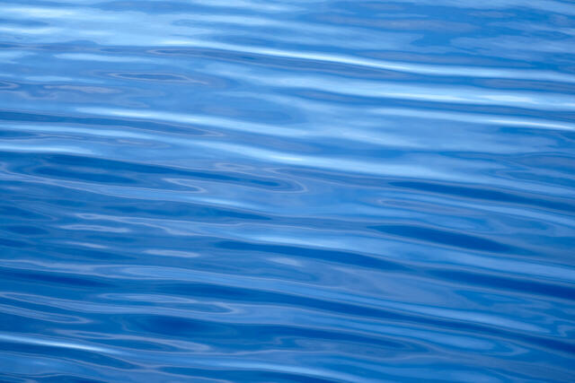 a blue abstract photograph of ripples in the ocean on the Hawaiian island of Maui.  Photographer Andrew Shoemaker captured this abstract image from a boat