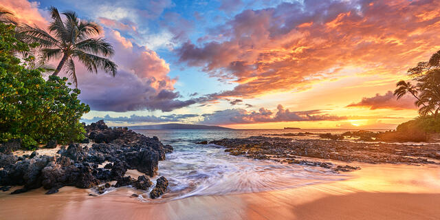 A very special panoramic view of sunset at a very special Secret Beach in Makena on the island of Maui, Hawaii.  Hawaii sunset pictures by Andrew Shoemaker