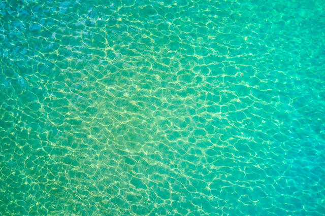 An aerial scene of amazing emerald Maui water color from the sky.  This unique abstract was captured by Andrew Shoemaker