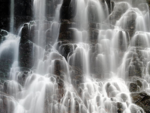 Falling Grace is a fine art photograph featuring a gracefully flowing waterfall from the melting waters of Mount Fuji in Japan by artist Andrew Shoemaker
