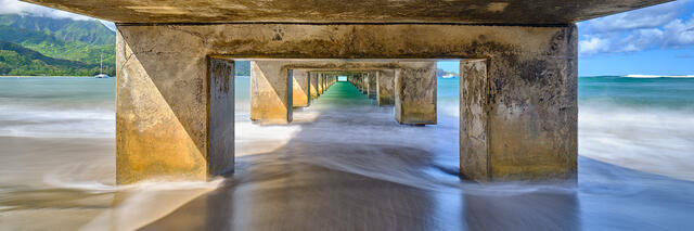 a panoramic photograph taken underneath the Hanalei Pier in Hanalei Bay on the Hawaiian island of Kauai.  Photographed by hawaiian artist Andrew Shoemaker