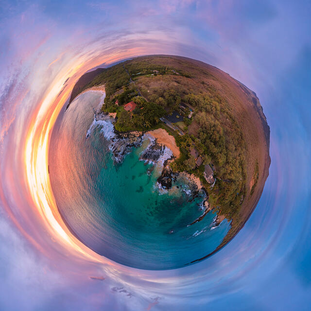 aerial panoramic view resembling a planet while above secret beach on Maui at sunset