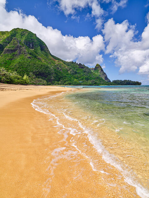 Makua Mood a photograph of the famous Tunnels Beach on the north shore of Kauai with lush green mountains in the background and clear Hawaiian water