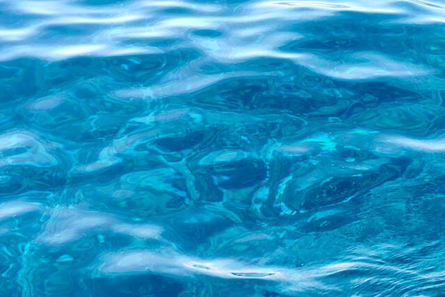 an abstract image of the molokini reef showing through the surface of the water from above.  Abstract ocean and coastal art from Andrew Shoemaker