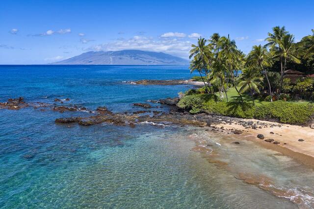 Fine art photograph of White Rock Beach in Wailea, Maui with palm trees along a tranquil shoreline and clear blue Pacific Ocean water