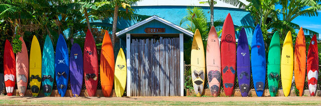 a very colorful surfboard fence in the same sequence as the rainbow found in Paia on the north shore of Maui