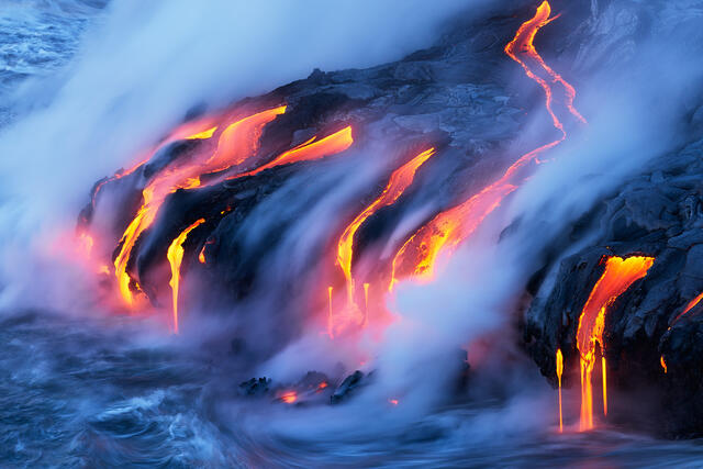 lava entering the ocean just before sunrise on the Big Island of Hawaii at Volcanoes National Park.