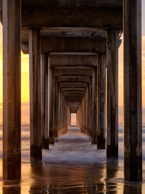 a vertical photograph titled Sea Portal down the famous Scripps Pier in La Jolla, California in the city of San Diego. California Fine Art Photography