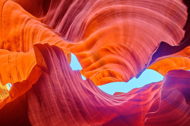 a fine art photograph from within lower antelope canyon in Arizona with orange, red, and purple colors. Fine art photography by Andrew Shoemaker