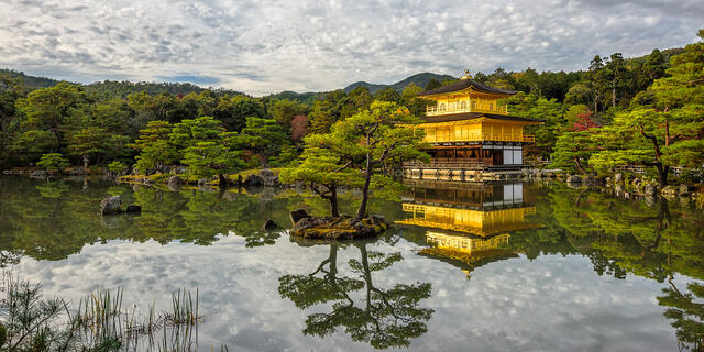 Golden Kinkaku-ji temple reflects on the water in Kyoto, Japan
