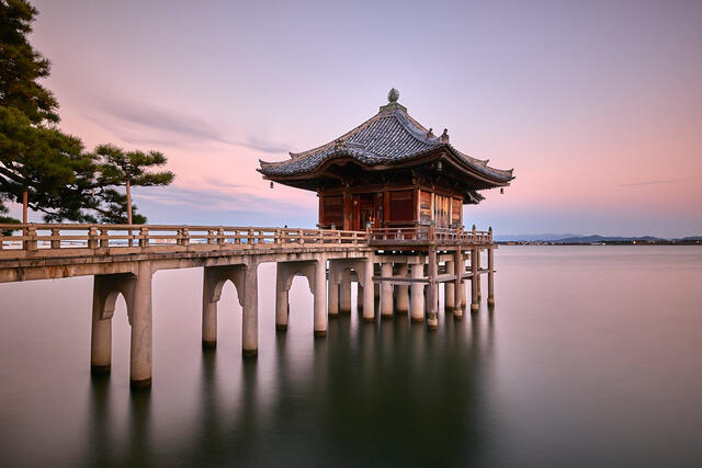 a long exposure of a floating temple with a bridge going out to at Ukimodo temple in Kyoto, Japan 