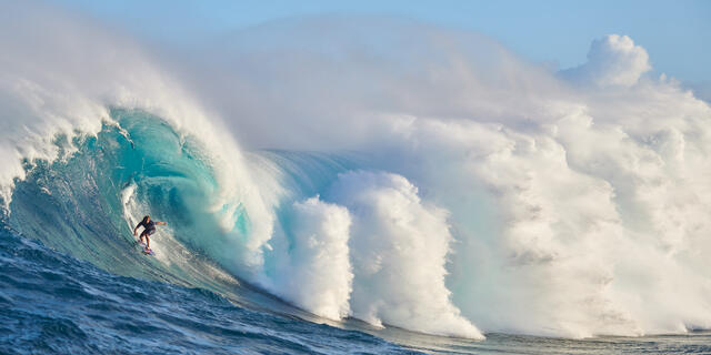 Unleashed is a panoramic fine art photograph of surfer Kai Lenny surfing the famous big wave on Maui's north shore known as Jaws (Peahi).