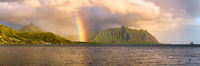 a beautiful panoramic photograph of the koolau mountain range with a rainbow at sunrise on the island of Oahu, Hawaii.  Landscape photo by Andrew Shoemaker
