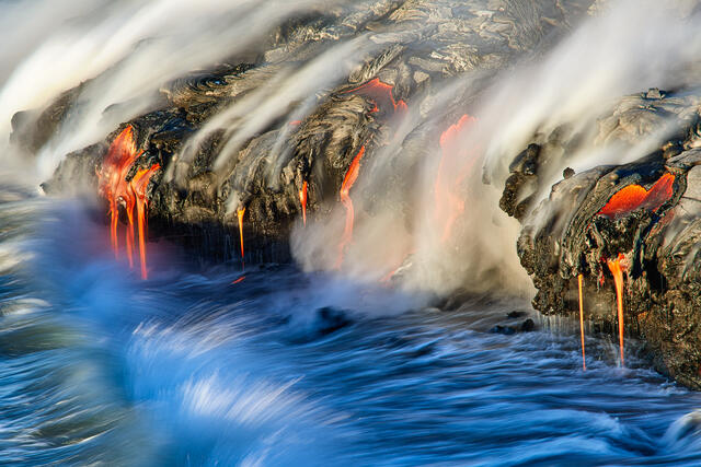 lava meets the ocean just after sunrise at the 61G lava flow on the Big Island of Hawaii