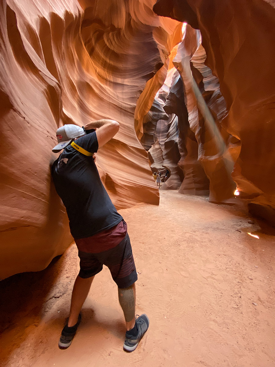 Photographer Andrew Shoemaker capturing light beams in Upper Antelope Canyon