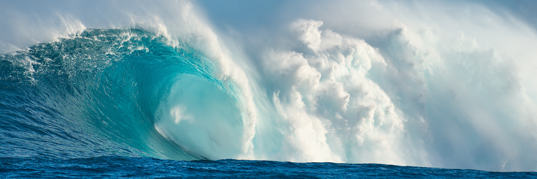 Aqua Thunder is a panoramic fine art photograph of the biggest wave in Hawaii called Jaws (Peahi) featuring an aqua blue barrel and the wave breaking.