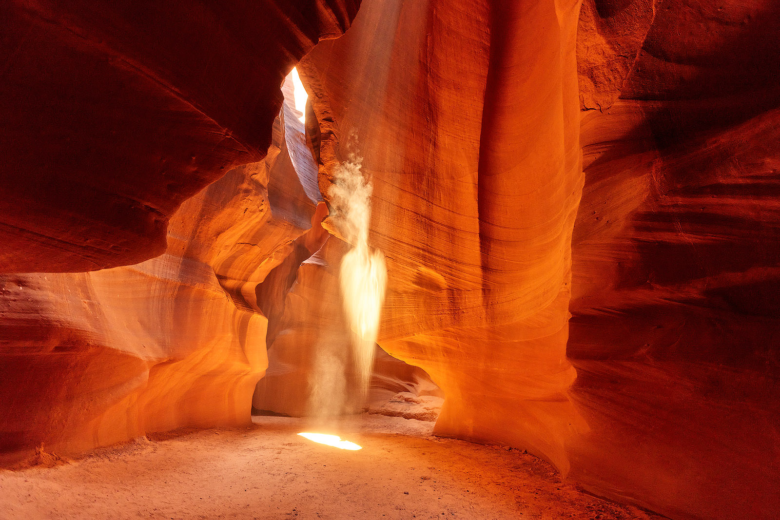 Arrowhead a beautiful fine art photograph in upper Antelope Canyon in Page, Arizona with an arrowhead shape in a light beam entering the canyon. Arizona Photography Art