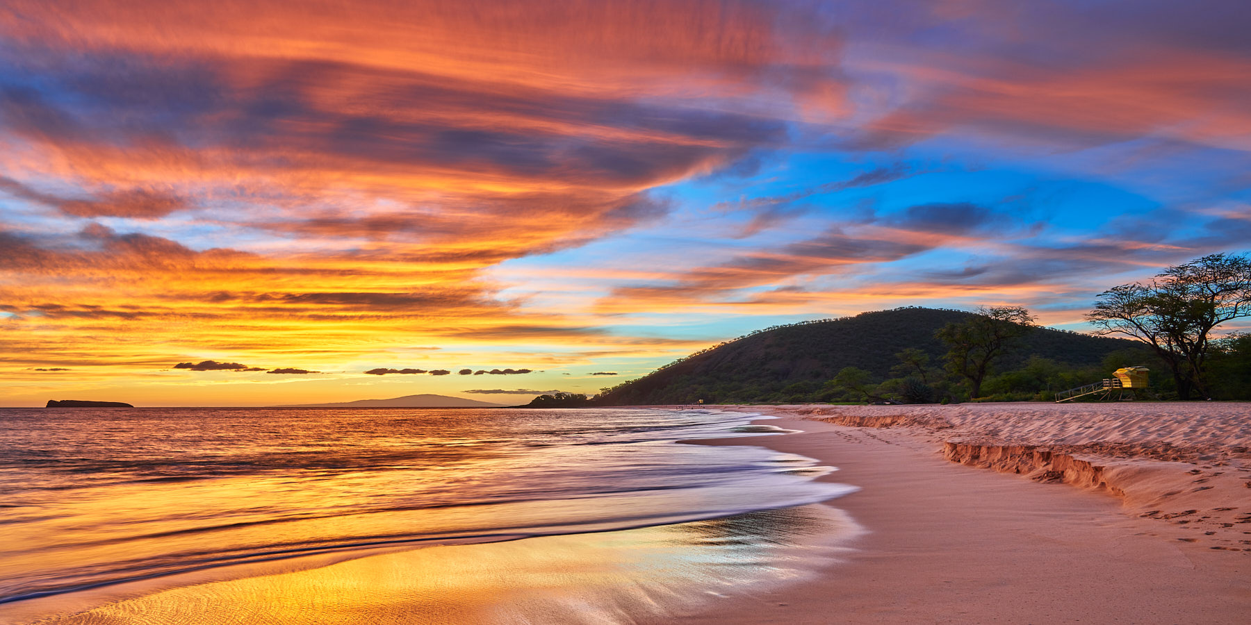 A glorious sunset erupts for this panoramic view of Big Beach (Makena State Park). The sky resembles almost a mirror of the beach itself for this special image