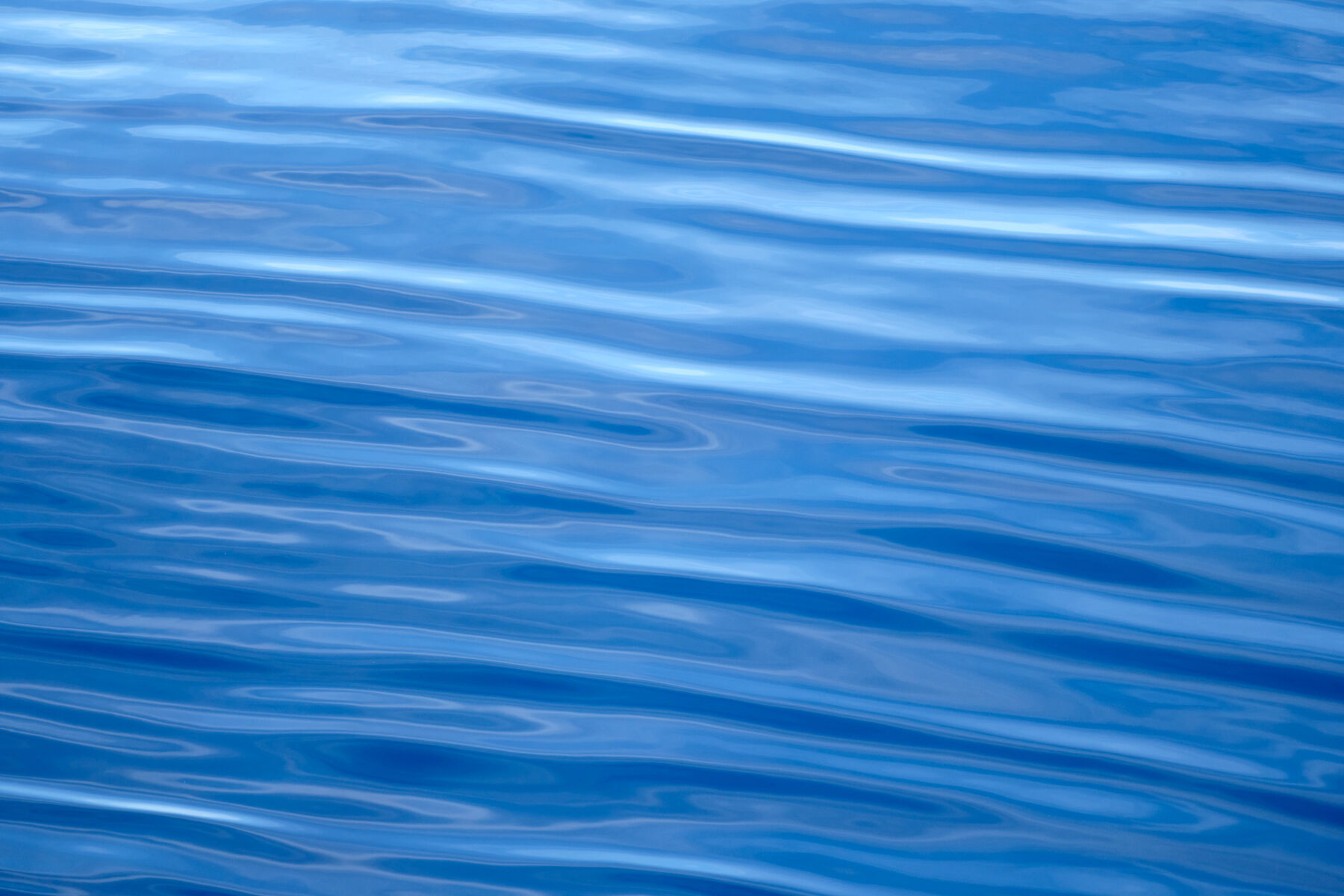 a blue abstract photograph of ripples in the ocean on the Hawaiian island of Maui.  Photographer Andrew Shoemaker captured this abstract image from a boat