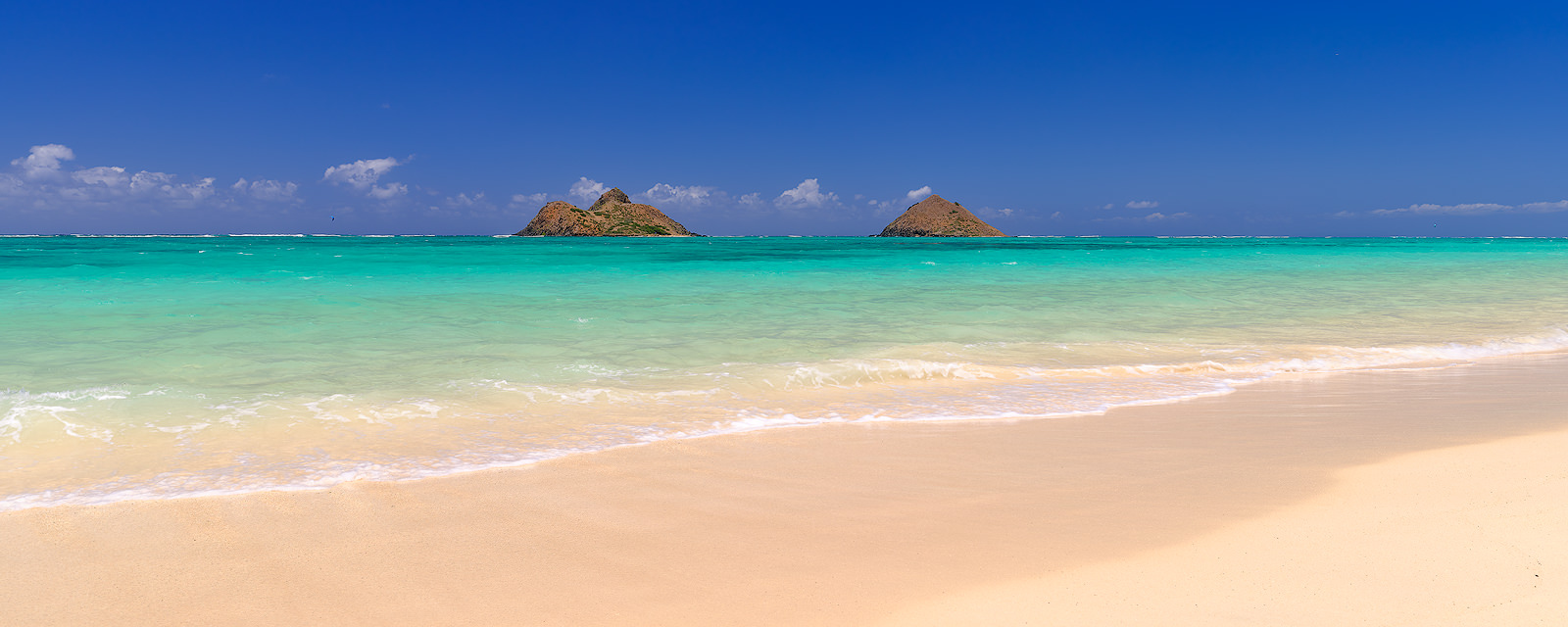 panorama print of the beautiful Lanikai Beach on the Hawaiian Island of Oahu.  Blue sky, amazing water color and the Mokolua Islands on the horizon 