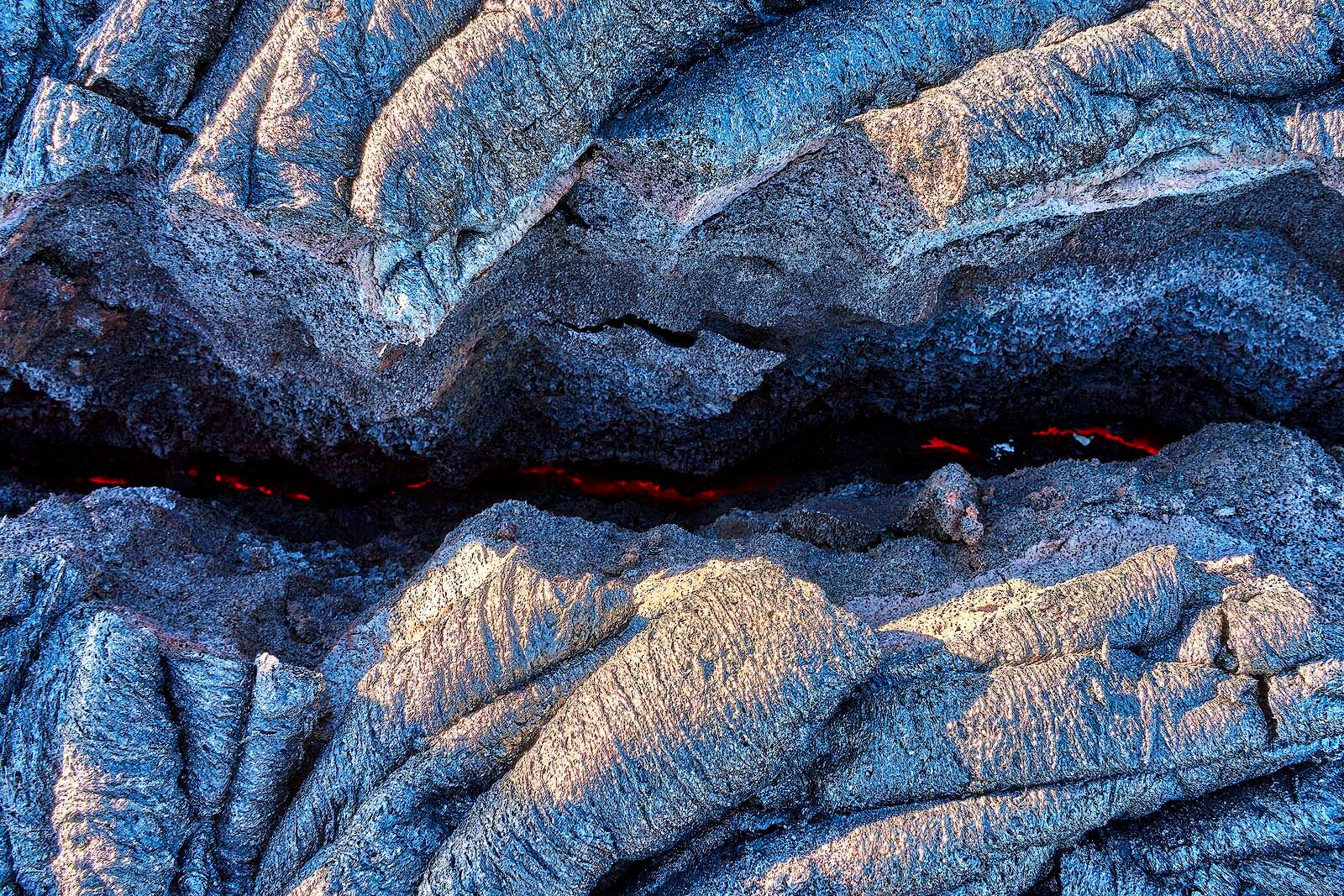 Burning Within the earth is glowing red hot through a crack in the dried lava on the big island of Hawaii. Lava Photography by Andrew Shoemaker