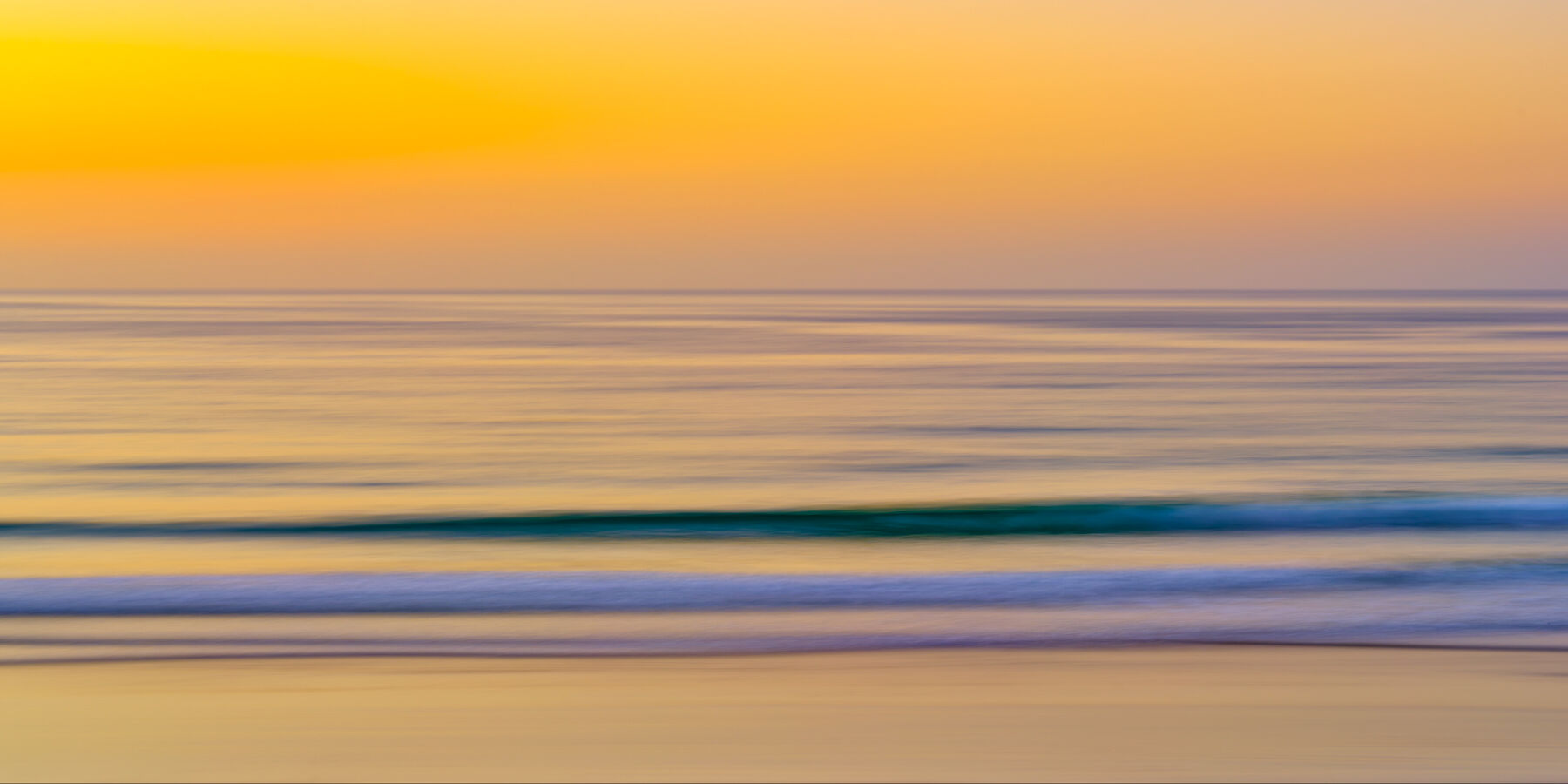 an abstract panoramic image of sunset at La Jolla shores beach creating a painterly feel with camera movement.  Abstract photography by Andrew Shoemaker