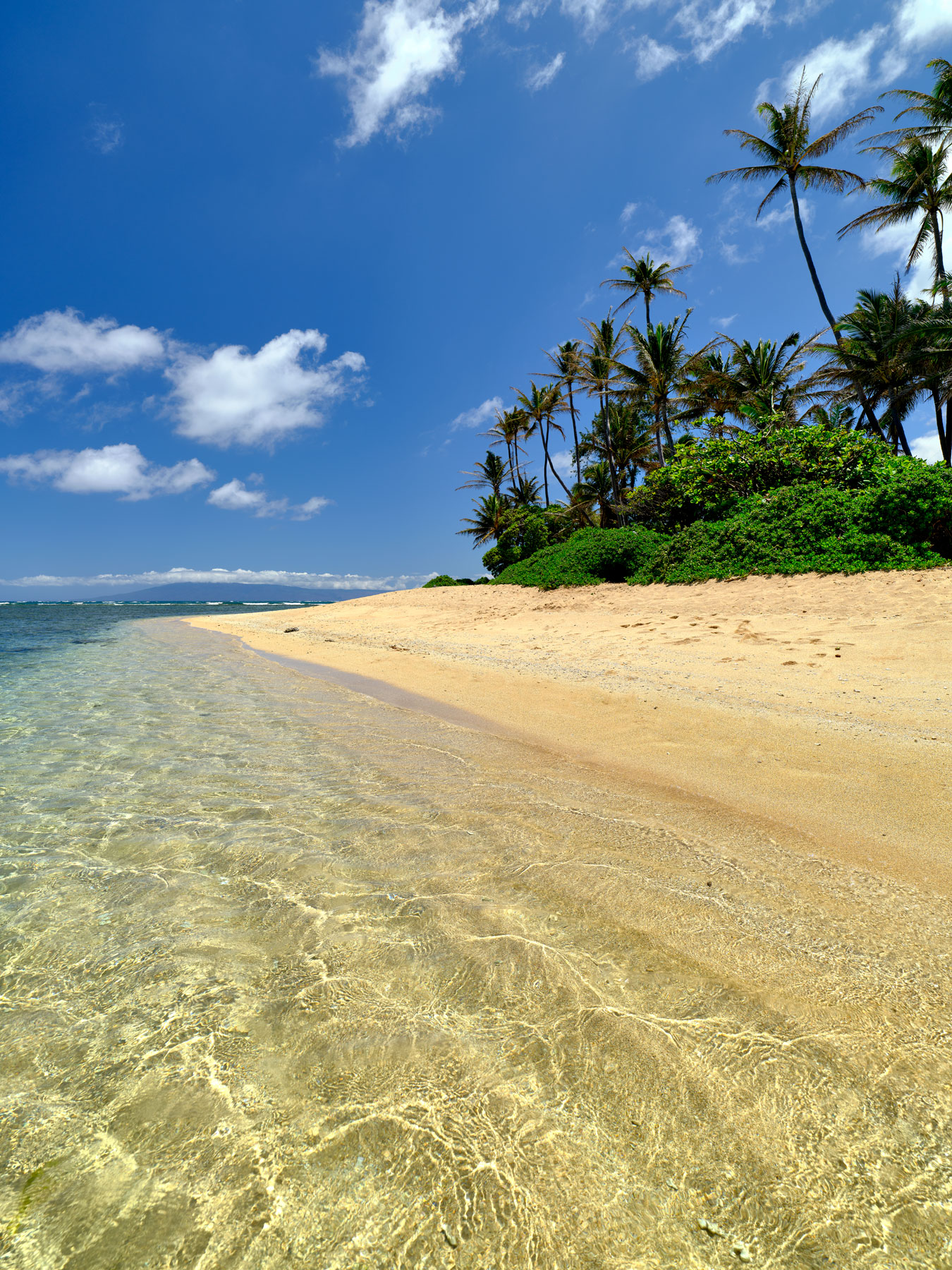 crystal clear tropical water washes up on to the beach at George Murphy beach park on the Hawaiian island of Molokai.  Tropical photography by Andrew Shoemaker