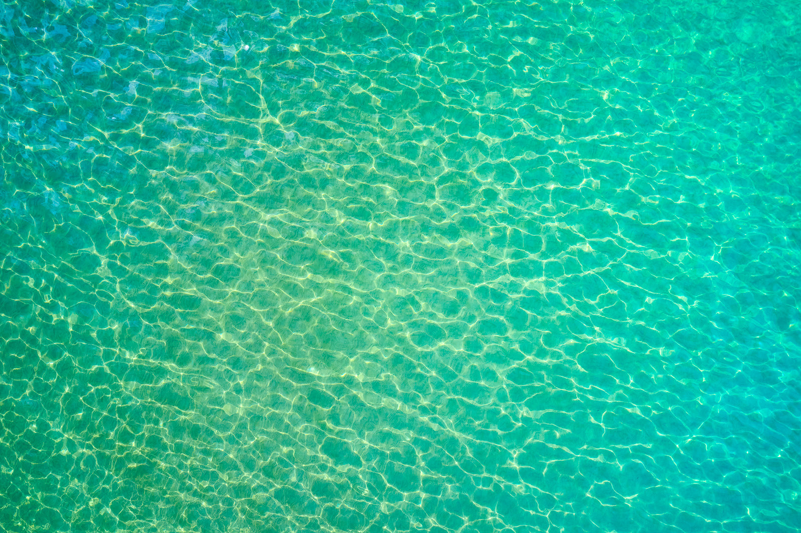 An aerial scene of amazing emerald Maui water color from the sky.  This unique abstract was captured by Andrew Shoemaker
