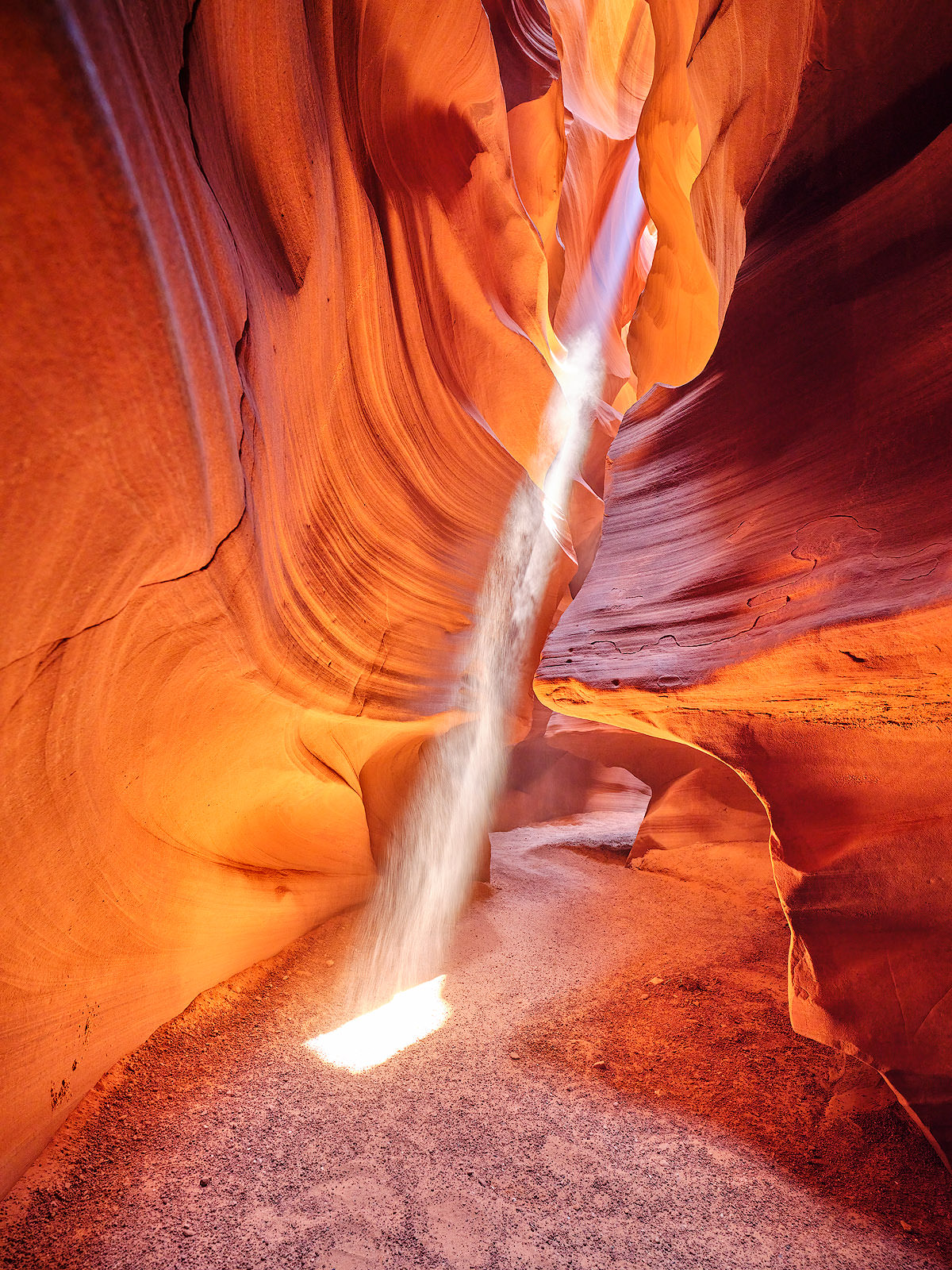 A glorious light beam shines down into upper antelope canyon in Page, Arizona.  American Southwest Fine Art Photography from Artist Andrew Shoemaker