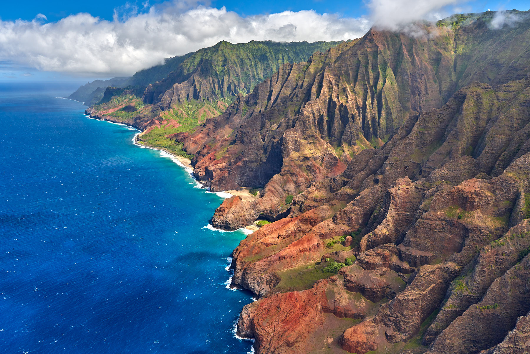a very dramatic angle of the na pali coastline on the Hawaiian Island of Kauai.  Photographed from a helicopter by Andrew Shoemaker