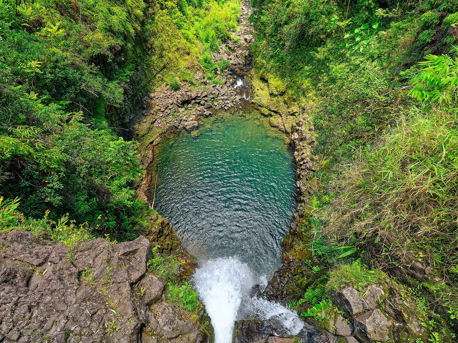 Free Fallin' view looking right down a waterfall from on top as the waterfall drops into a lush valley near Hana, Hawaii