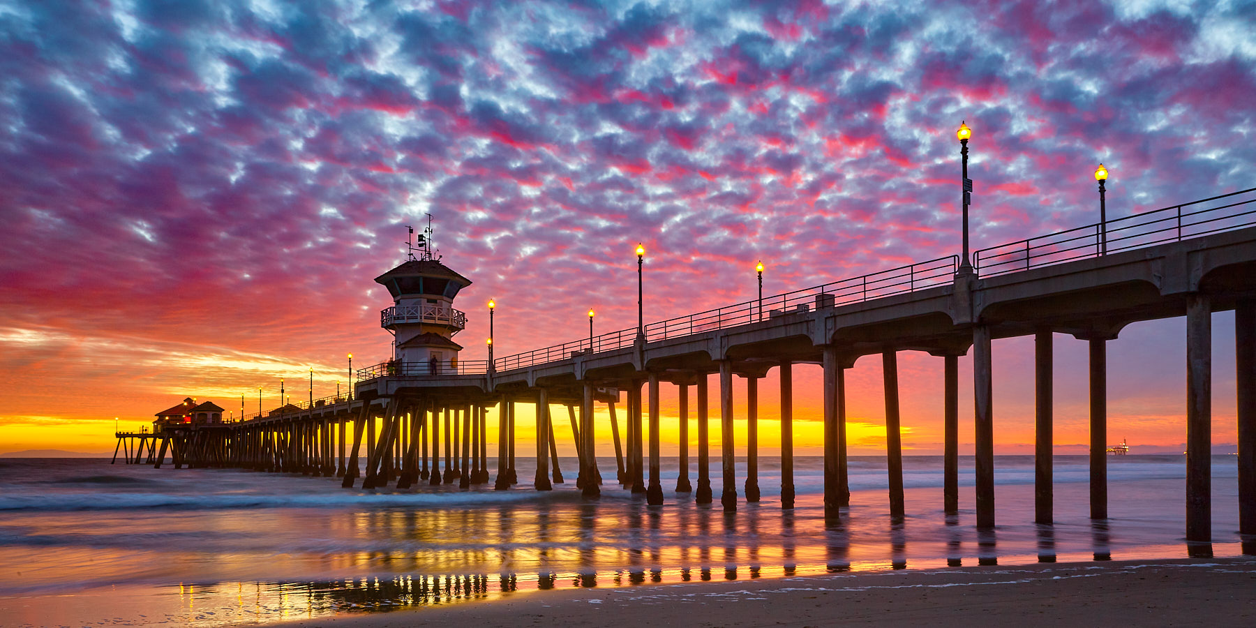 panoramic image of sunset at the beautiful Huntington Beach pier in Huntington Beach, California